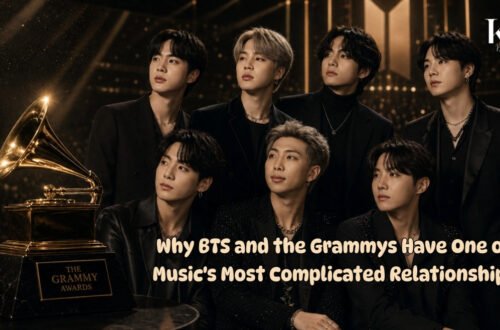 Seven-member K-pop group beside a Grammy trophy on an awards stage